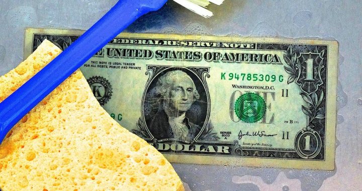Dish sponge and USA dollar note signifying money laundering